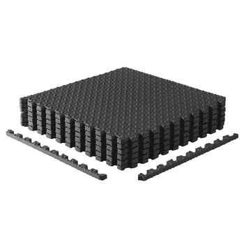 Black foam puzzle floor mat with textured grip dots and interlocking edges
